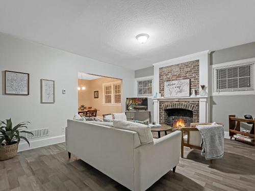 a living room with a couch and a fireplace at Chic 2BR Duplex Free Parking near Hospitals in Des Moines