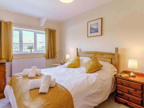 a bedroom with a large bed with towels on it at 3 Bed in Lampeter 86506 in Cellan