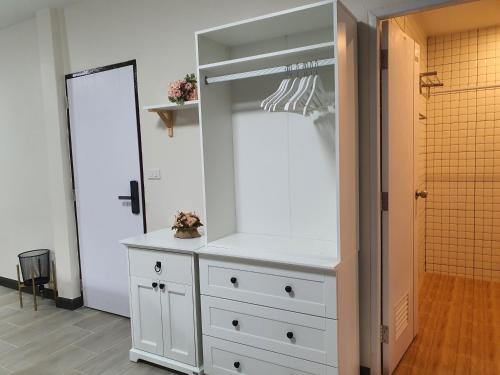 a white dresser in a room with a closet at 3 BR Cozy Home Skytrain View BKK in Bangkok