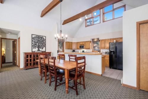 a kitchen with a wooden dining room table and chairs at Boulder Brook on Fall River in Estes Park