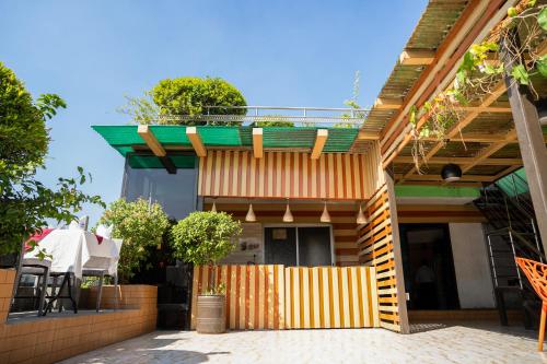 a house with a wooden fence in front of it at Hotel Air Inn Ltd - Airport View in Dhaka