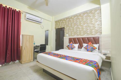 1 dormitorio con 1 cama grande y escritorio en FabHotel Magadh Crystal en Patna