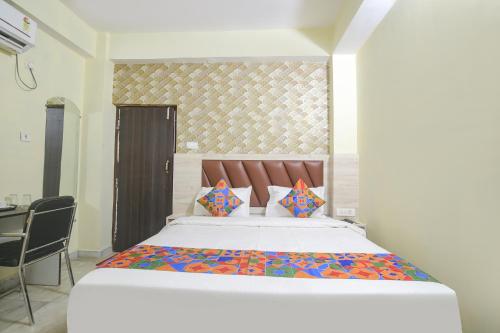 a bedroom with a large bed in a room at FabExpress Magadh Crystal in Patna