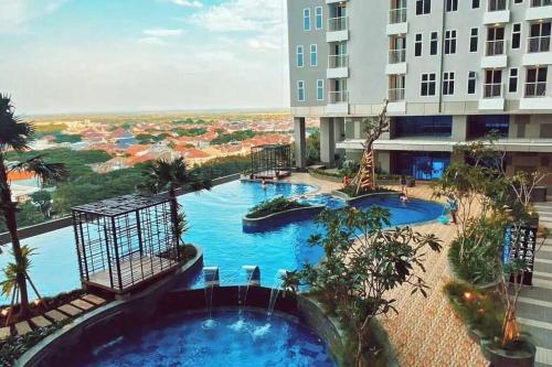 an overhead view of a swimming pool in a building at Cozy Apartment on Top of Pakuwon City Mall in Surabaya