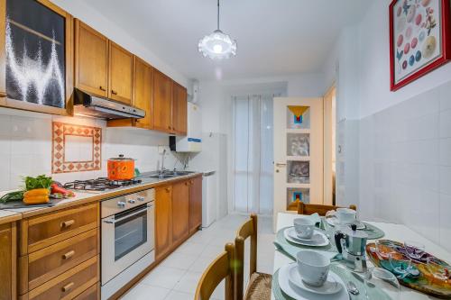 a kitchen with a table and a dining room at Eleonora House - Happy Rentals in Alassio