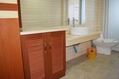a bathroom with a sink and a toilet at Dansavanh Vientiane Hotel in Vientiane