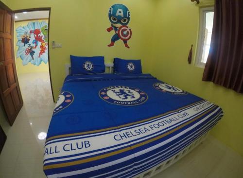a bedroom with a bed with a captain mario sign on it at Green house Pool Villa in Cha Am