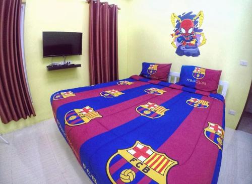 a bedroom with a large bed with a superhero bedspread at Green house Pool Villa in Cha Am