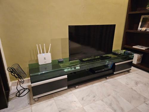 a large flat screen tv sitting in a living room at Cosy Home + Mini Golf in Kuantan in Kuantan