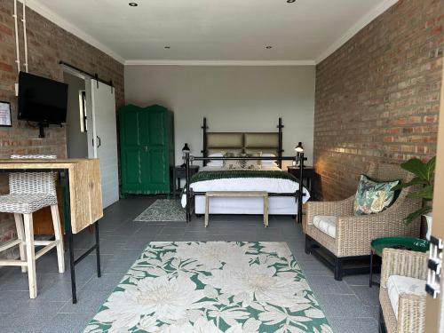 a bedroom with a bed and a brick wall at Welgemoed Villa in Bellville
