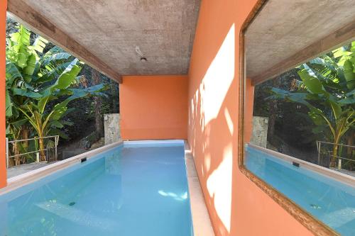 a swimming pool in a house with two windows at Apartment View And Pool - Happy Rentals in Agno
