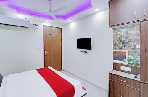 a bedroom with a bed and a tv on the ceiling at Private rooms in Jagatpuri- Near Anand Vihar in New Delhi