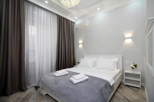 a bedroom with a bed with two towels on it at Апартаменты бизнес-класса в ЖК Amir in Almaty