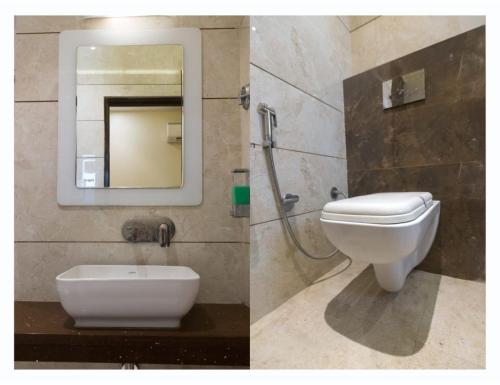 a bathroom with a white toilet and a mirror at Hotel Urban Galaxy Square, Amritsar in Amritsar