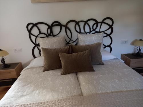 a bedroom with a large white bed with a black headboard at SOBERANA JAVEA in Jávea