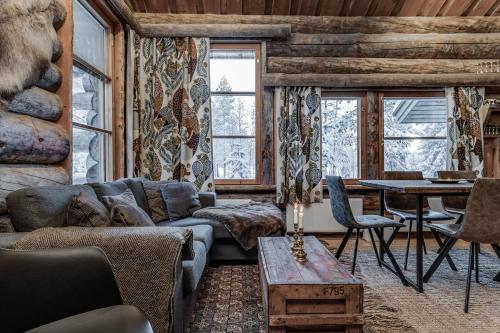 a living room with a couch and a table at Ruka Villa Pipo slopes, skiing, lake in Ruka