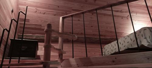 a wooden room with stairs in a wooden cabin at La chambre Nature chez les garçons in Saint-Paul-sur-Yenne