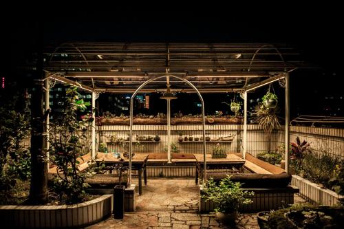 a pavilion with a table and chairs in a garden at Arthur's Roof-Top in Chengdu