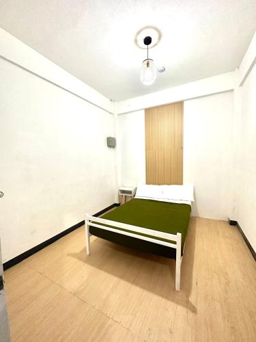 um quarto com uma cama com um colchão verde em Zz Dormitel em Nabua
