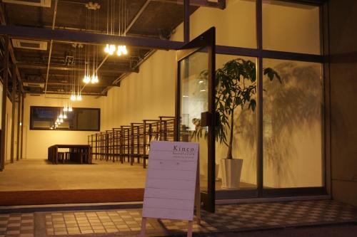 
a large white building with a sign on it at Kinco. hostel+cafe Takamatsu, Setouchi in Takamatsu
