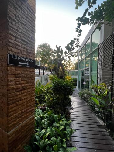 a sign for a fitness room next to a building at Vimanlay A302 - Happiness Elevated in Ban Bo Talung