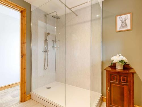 a shower with a glass enclosure in a bathroom at 1 Bed in Glastonbury 86979 in Edington