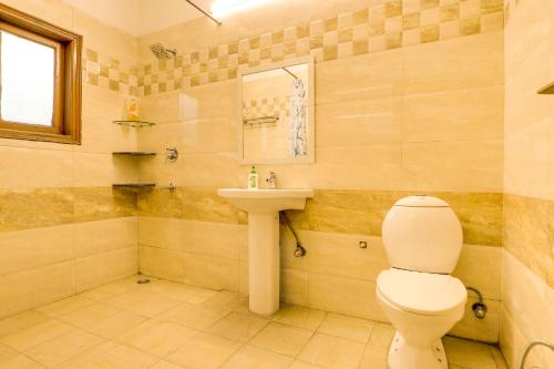 a bathroom with a toilet and a sink at House Of Comfort Greater Noida in Greater Noida
