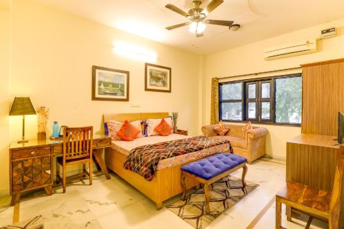 a bedroom with a bed and a desk at House Of Comfort Greater Noida in Greater Noida