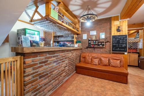 a bar in a restaurant with a brick wall at Resort 7 Crai - Cabana Craiul Crailor in Zărneşti