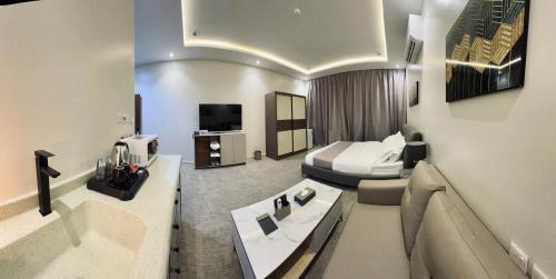 a hotel room with a bed and a bathroom at قمم بارك الباحة Qimam Park Hotel 7 in Al Baha