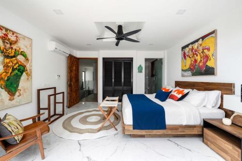 a bedroom with a bed and a ceiling fan at Luxury Blue Coco Sea View Villa - 4x4 SUV included in Koh Samui 