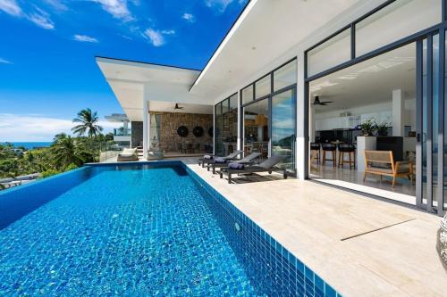 a swimming pool in a villa with a view at Luxury Blue Coco Sea View Villa - 4x4 SUV included in Koh Samui 