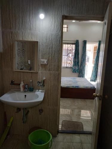 a bathroom with a sink and a bed at Alok Premanand's House in Raipur