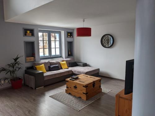 a living room with a couch and a table at Superbe appartement duplex en hyper centre in Le Puy en Velay