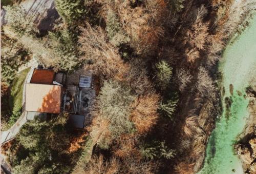 an aerial view of a house on a hill next to the water at Four Elements in Palfau