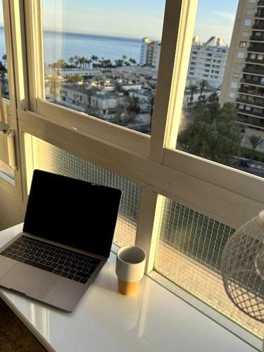 a laptop sitting on a table in front of a window at IRIVI 9 Apartment in Aguadulce