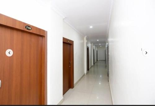 einen Korridor eines Krankenhausflurs mit einer Tür und einem Korridorngthngthngthngth in der Unterkunft Hotel Shree Krishna Residency By BookingCare in Satna