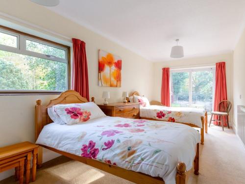 a bedroom with two beds and a window at 2 Bed in Scarning SHRN8 in East Dereham