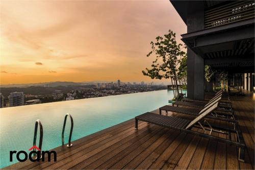 two benches sitting on a deck with a view of the water at ViiA Residences Kuala Lumpur in Kuala Lumpur
