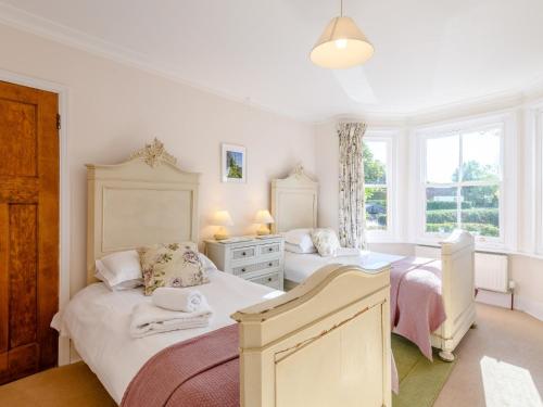 a bedroom with two beds and a window at 5 Bed in Godshill NFL35 in Godshill