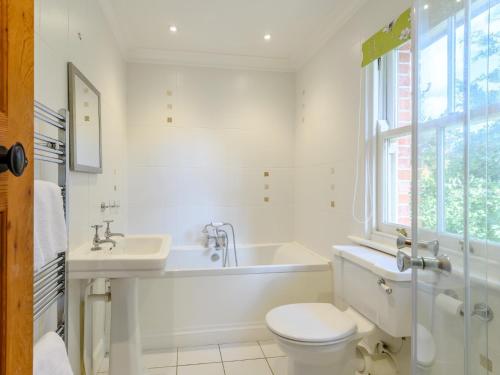 a bathroom with a tub and a toilet and a sink at 5 Bed in Godshill NFL35 in Godshill