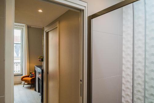 a hallway with a sliding glass door to a room at Appartement 11 place d'Alliance in Nancy