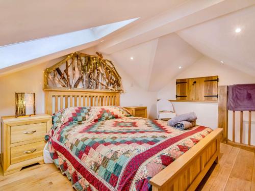 a bedroom with a large bed and a wooden dresser at 2 Bed in Rothbury 88270 in Rothbury