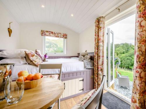 a bedroom with a bed and a table at 1 Bed in Patterdale 89510 in Deepdale
