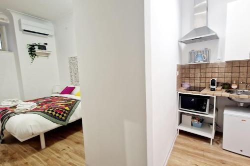 a small bedroom with a bed and a kitchen at Small & cozy near Piazza Navona in Rome