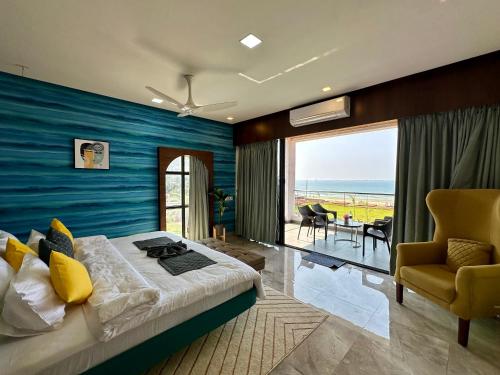a bedroom with a bed and a view of the ocean at Aqualina in Bhogwe