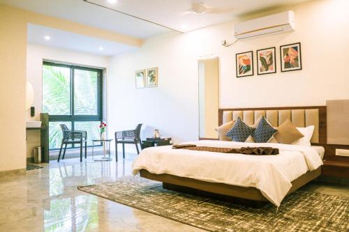 a bedroom with a large bed and a living room at Aqualina in Bhogwe