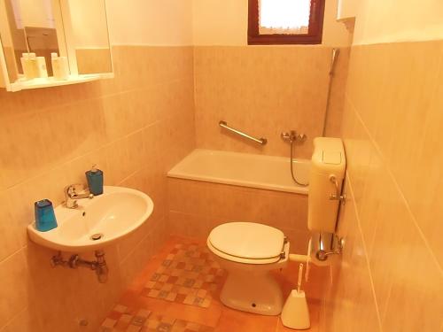 a bathroom with a toilet and a sink at Sunflower Apartment in Opatija