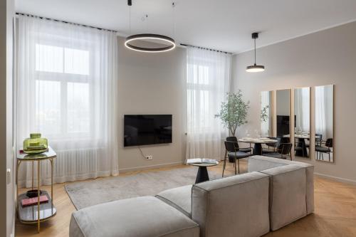 a living room with a couch and a tv at OldTown&River View Hoffmann B14 in Riga