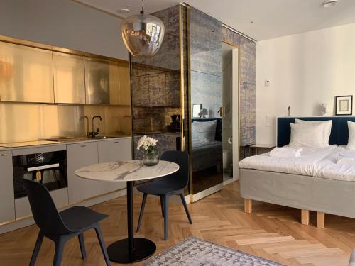 1 dormitorio con 1 cama, mesa y sillas en Bob W Koti Ullanlinna, en Helsinki